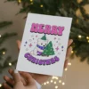 A cheerful bisexual Christmas card showcasing a polar bear and a colorful Christmas tree, perfect for the holiday season.