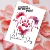 Valentine's card with "You Make My Heart Purr" text, pink paw print, and heartbeat line. Surrounded by rose petals, conveying love and affection.