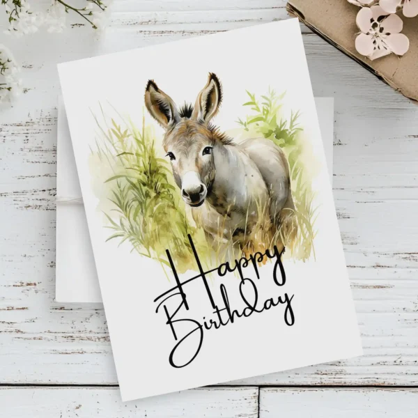 Happy birthday donkey watercolor art featuring a joyful donkey and a festive "Happy Birthday" greeting for a card.