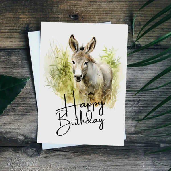 Watercolor illustration of a cheerful donkey with a "Happy Birthday" message, perfect for a printable birthday card.