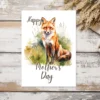 Whimsical watercolor red fox design on a Mother's Day card, great for printing and celebrating mothers.