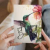 Beautiful green hummingbird birthday card in watercolor, adorned with vibrant flowers for a festive touch.