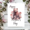 Sweet bear illustration on a Mother's Day card, decorated with lovely flowers for a special touch.