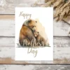 Delightful watercolor depiction of a grizzly bear mom with her cub, suitable for a Mother's Day card.