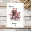 Printable Mother's Day card featuring a cute bear surrounded by colorful flowers. Perfect for celebrating moms!