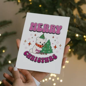 Lesbian Merry Christmas card featuring a polar bear in a hat beside a decorated Christmas tree, celebrating the holiday spirit.