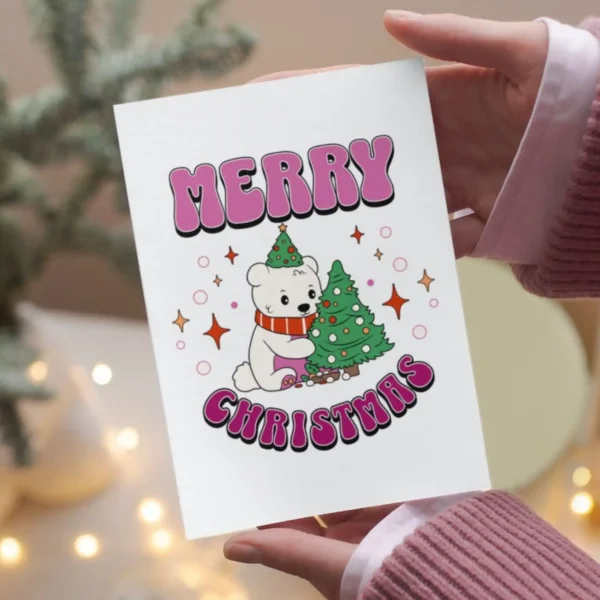 A festive lesbian Christmas card with a polar bear wearing a hat and a colorful Christmas tree, perfect for holiday greetings.