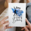 Libra birthday card highlighting character traits, set on a blue watercolor background that reflects the air element.