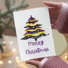 Nonbinary Christmas card with a beautiful watercolor depiction of a Christmas tree.
