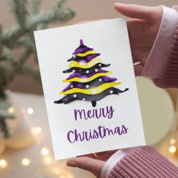 Nonbinary Christmas card with a beautiful watercolor depiction of a Christmas tree.