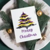 Cheerful printable card with a watercolor Christmas tree, designed for nonbinary holiday celebrations.