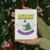 A festive nonbinary Christmas card featuring a cheerful polar bear wearing a colorful scarf and a snowflake background.
