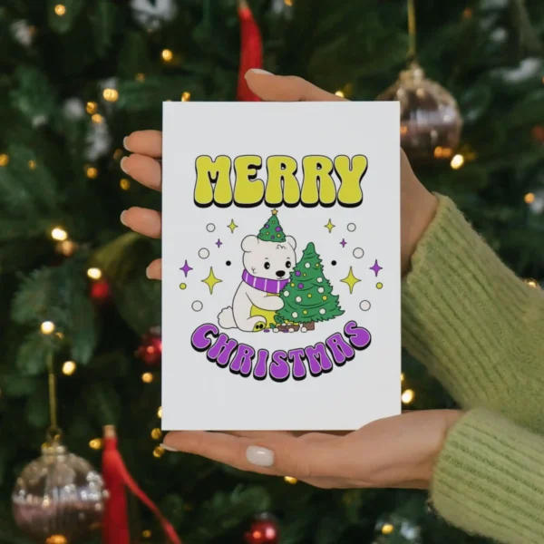 A festive nonbinary Christmas card featuring a cheerful polar bear wearing a colorful scarf and a snowflake background.