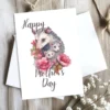 Charming watercolor card for Mother's Day, showcasing a mother opossum and her adorable babies.