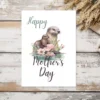 Sweet otter mom and baby depicted on a printable Mother's Day card, capturing the essence of maternal love and joy.