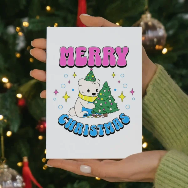 A festive card featuring a cartoon bear and a colorful Christmas tree, celebrating pansexual pride.