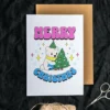 Printable Christmas card with a cheerful cartoon bear and a vibrant tree, highlighting pansexual themes.