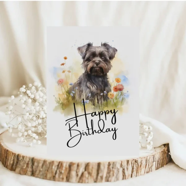 Happy birthday card showcasing a Affenpinscher in a watercolor scene, complete with a festive "Happy Birthday" greeting.