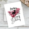 Festive Aries birthday card featuring character traits, with a bold red watercolor background reflecting the fire element.