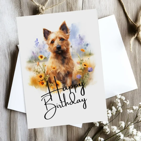 Charming birthday card showcasing a Australian Terrier in a serene setting, complete with a "Happy Birthday" message.