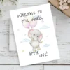 Sweet watercolor card of a baby elephant with balloons, welcoming a new baby with the phrase "Welcome to the world, little one!"