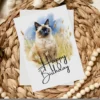 Charming watercolor illustration of a Balinese cat on a birthday card, set in nature with a "Happy Birthday" note.