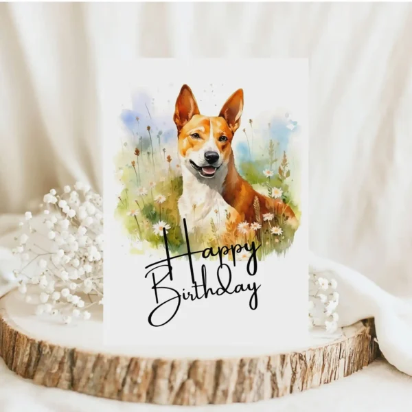 Watercolor birthday card featuring a happy Basenji dog in a natural setting with a "Happy Birthday" message.