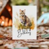 Watercolor birthday card showcasing a Bengal cat in a serene landscape, complete with a "Happy Birthday" message.