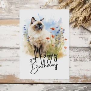 Whimsical watercolor card featuring a Birman cat in nature, celebrating with a "Happy Birthday" message for cat lovers.