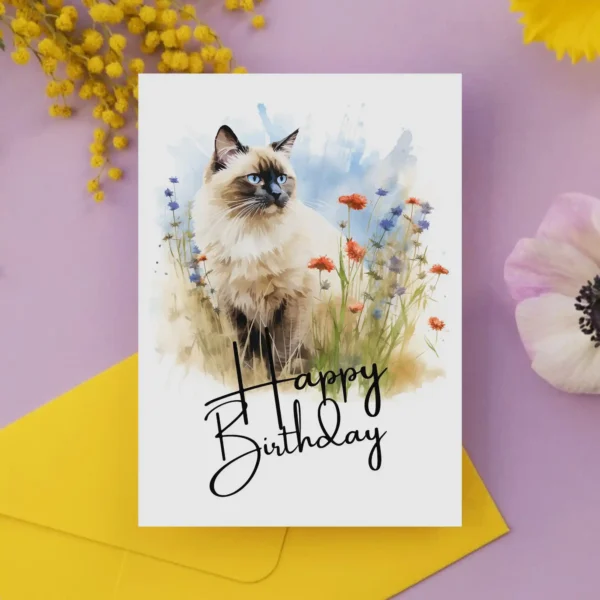 Charming watercolor birthday card showcasing a Birman cat in a serene landscape, complete with a "Happy Birthday" note.