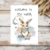 Watercolor drawing of a cute bunny with the text "Welcome to the world, little one!" for a new baby card.
