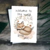 Sleepy boho fox new baby card in watercolor style, adorned with flowers and the message: "Welcome to the world, little one!"