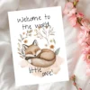 Watercolor new baby card featuring a sleepy fox and floral elements, with the message: "Welcome to the world, little one!"