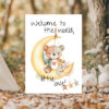 Charming greeting card depicting a teddy bear on the moon, featuring the message, "Welcome to the world, little one!"