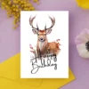 Delightful watercolor drawing of a deer on a birthday card, featuring the words "Happy Birthday" in a joyful style.