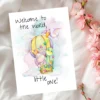A cute greeting card showing a cartoon bird with a balloon, celebrating a new baby with the text, "Welcome to the world, little one!"