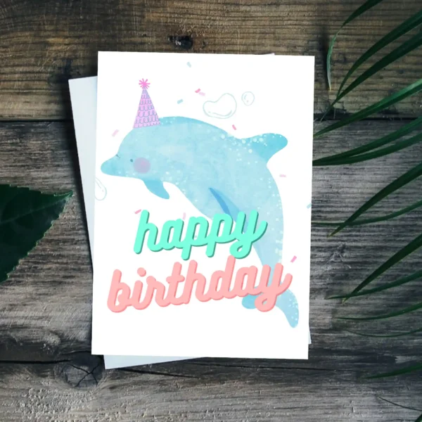 Printable kids birthday card featuring dolphin in a party hat with ocean background
