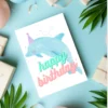 Dolphin-themed birthday card, watercolor style with festive sea life design