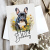 Cheerful watercolor birthday card of a French bulldog in a natural scene, featuring a "Happy Birthday" message.