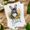 Watercolor birthday card featuring a happy French bulldog in a natural setting with a cheerful "Happy Birthday" message.