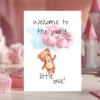 Watercolor teddy bear card with pink balloons and the message, "Welcome to the world, little one!" for new baby celebrations.