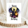 A birthday card depicting a purple dragon with a lantern, beautifully framed by colorful flowers in a gothic design.