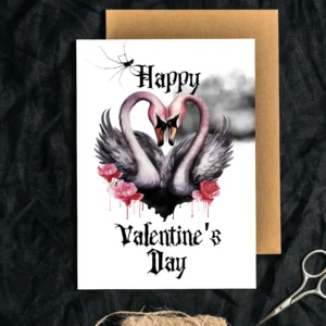 Printable Gothic Valentine's Day card featuring two pink swans forming a heart with their necks against a cloudy background.
