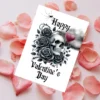 Happy Valentine's Day card with a skull, black roses, and a dark cloud, blending romance with a gothic twist.