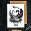 A Gothic Valentine's card featuring a white and black swan, their necks forming a heart.