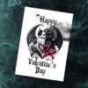 Gothic Valentine's card on marble; features two cats with bat wings, one white, one black, thorns are forming a heart. Text: "Happy Valentine's Day."