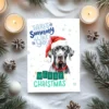 Holiday card with a Great Dane in Santa hat and wintery scene