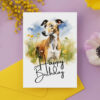 Watercolor birthday card featuring a happy greyhound in a natural setting with a "Happy Birthday" message.