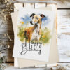 Cheerful birthday card with a greyhound in a natural scene, showcasing a watercolor design and "Happy Birthday" text.