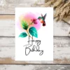 Adorable hummingbird birthday card design, showcasing a bird sipping from a flower in a lovely watercolor style.